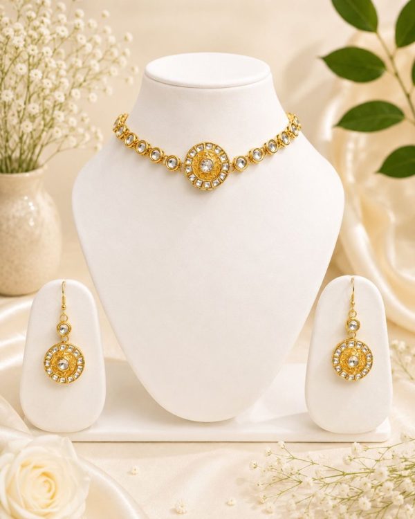 Gold plated Kundan necklace set displayed on jewellery stand with matching earrings
