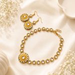 Flat lay view of gold plated Kundan necklace and earrings set on decorative background