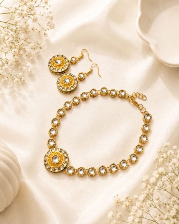 Flat lay view of gold plated Kundan necklace and earrings set on decorative background