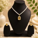 Pearl pendant necklace set displayed on black jewellery stand with matching stud earrings