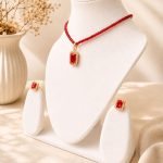 Gold plated red crystal pendant necklace with matching earrings