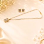 Elegant white stone pendant necklace set with matching earrings