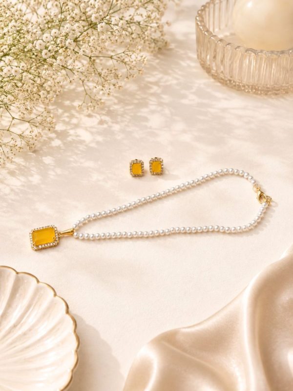 Elegant yellow gemstone pendant necklace set with matching earrings