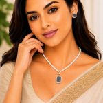 Woman wearing blue crystal pearl pendant necklace set with matching stud earrings
