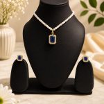 Blue crystal pendant necklace set displayed on black jewellery stand