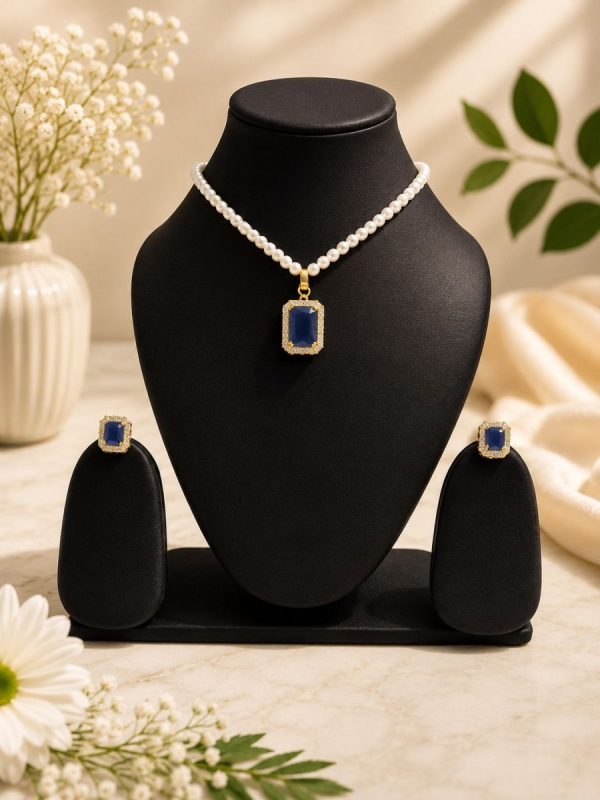 Blue crystal pendant necklace set displayed on black jewellery stand
