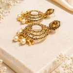 Ethnic gold tone chandbali earrings with white pearl accents