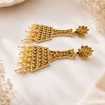 Side view of gold plated pearl jhumka earrings for women