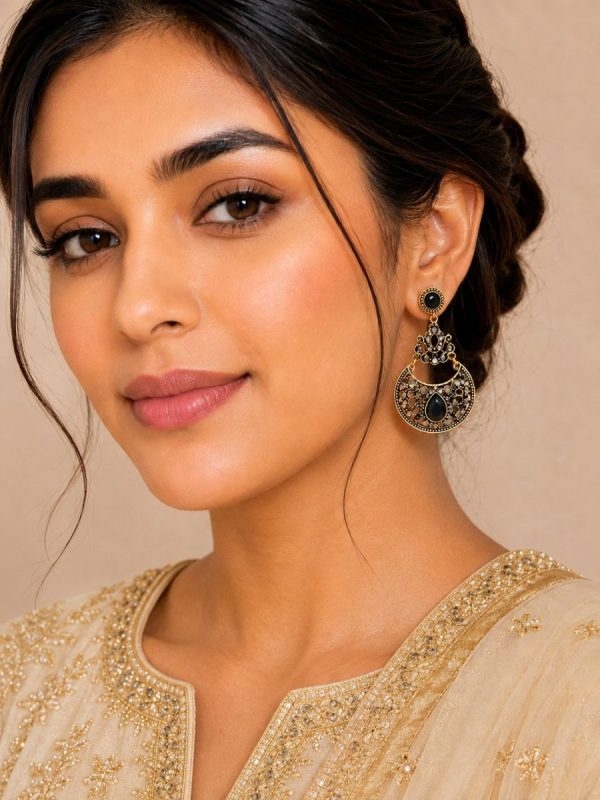 Woman wearing antique black stone dangle earrings with ethnic outfit