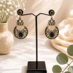 Designer ethnic earrings featuring black stone detailing front view on stand