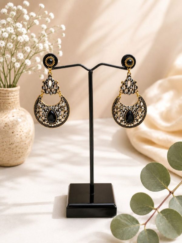 Designer ethnic earrings featuring black stone detailing front view on stand