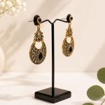 Vintage style black stone dangle earrings for festive wear-side view on stand