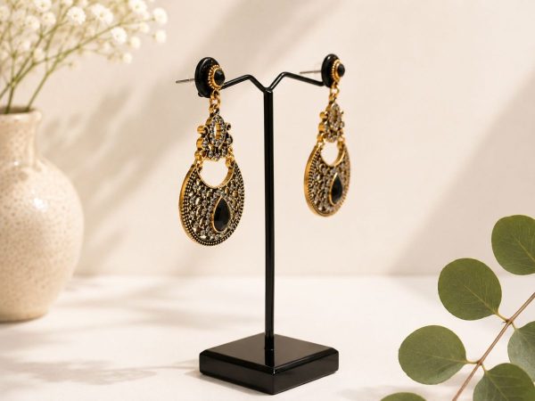 Vintage style black stone dangle earrings for festive wear-side view on stand