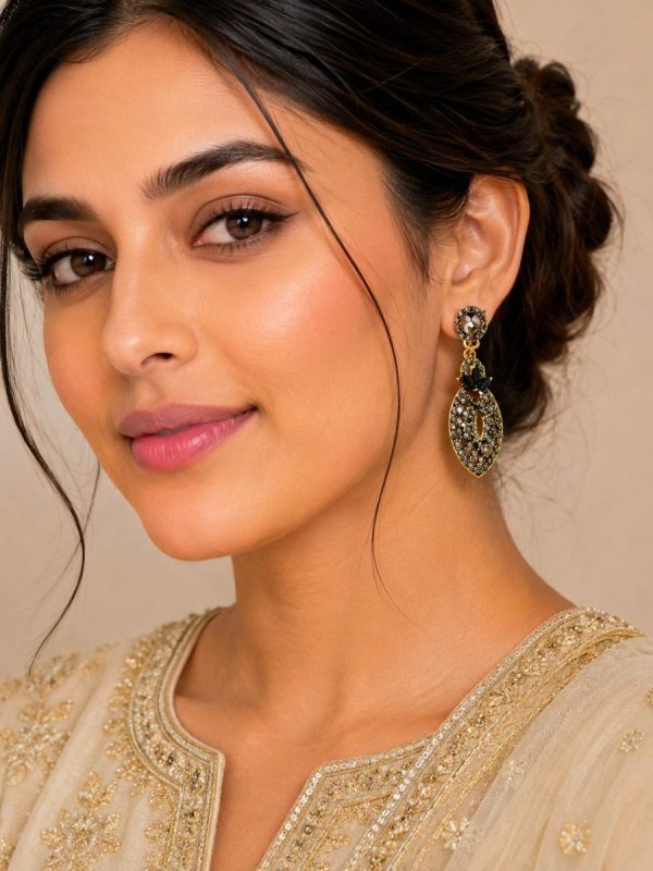 Woman wearing antique black stone drop earrings with ethnic outfit