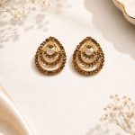 Close-up view of antique gold stud earrings for women