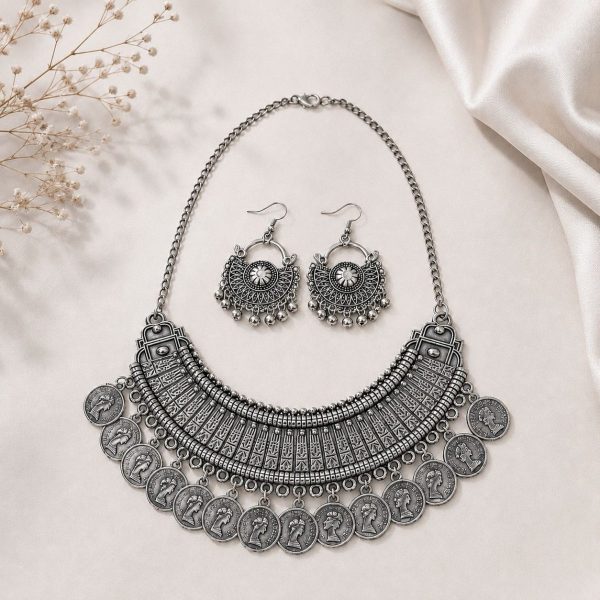 oxidesed coin necklace set on stand on flat surface