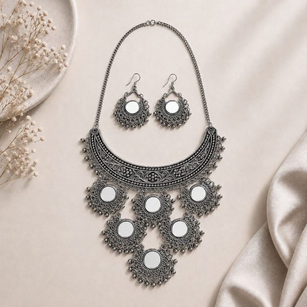 mirror necklace set with earrings on flat surface